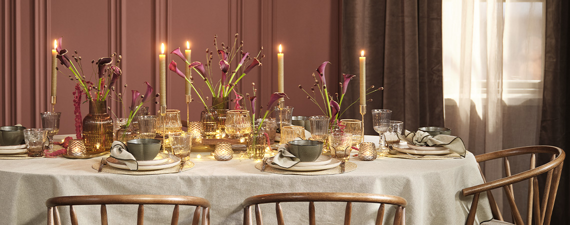 Kersttafelsetting met feestelijke items die de feestdagen inluiden Feestelijke kersttafelsetting met diepe kleuren zoals bordeaux, groen en grijs