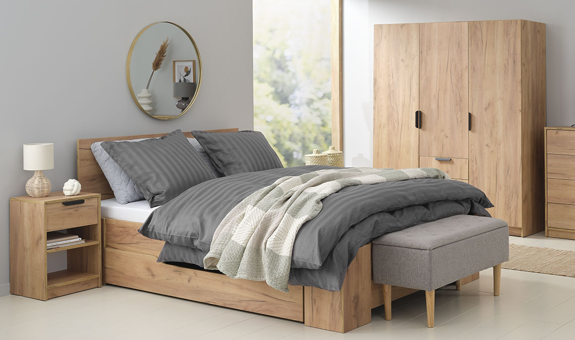 Slaapkamer met tweepersoonsbed, kledingkast, nachtkastje en bank.