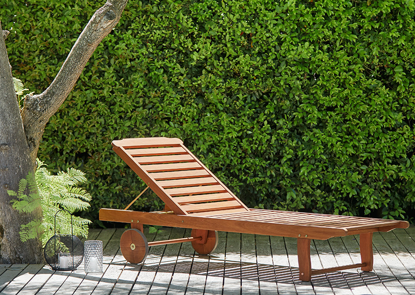 Wooden sun lounger on a patio