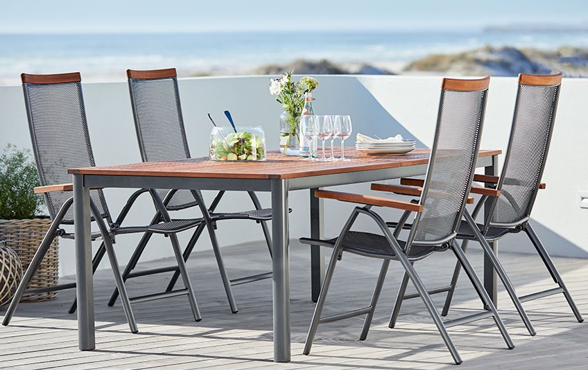 YTTRUP garden table and LARVIK recliner chairs Garden furniture out of metal and hardwood on a patio