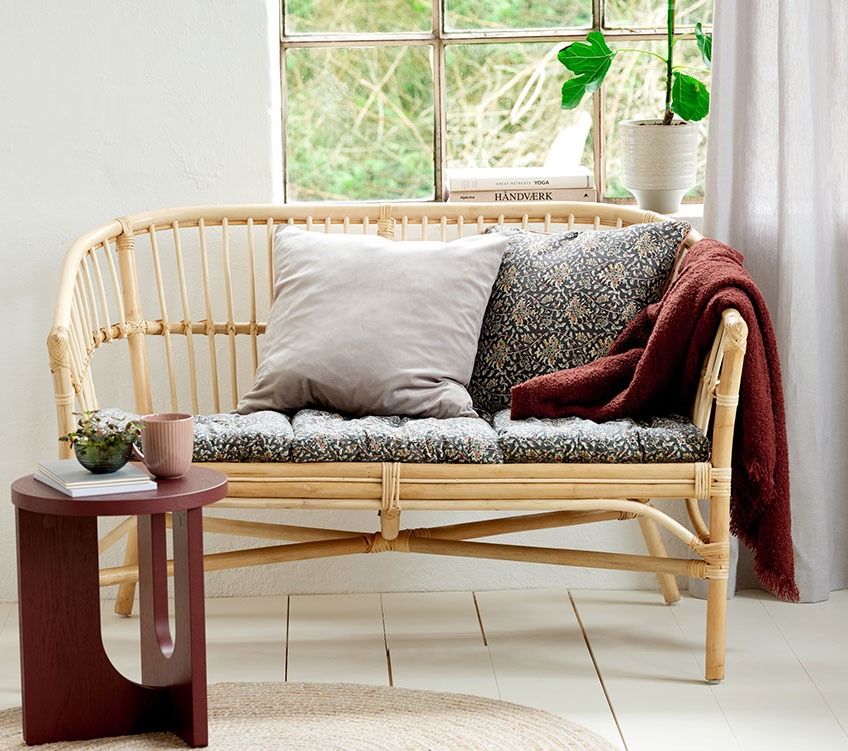 LISELEJE rotan 2-zitsbank met TOPPKLOKKE zitkussens en sierkussens, ROSE plaid en ARCH bijzettafel 2-zitsbank van rotan met zitkussens en sierkussens, bordeaux plaid en een ronde bijzettafel