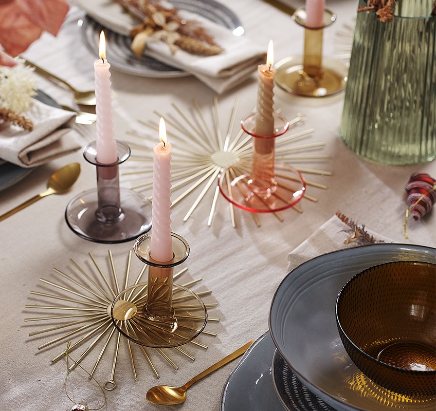 Gold decoration, candlesticks and candles on New Year’s table