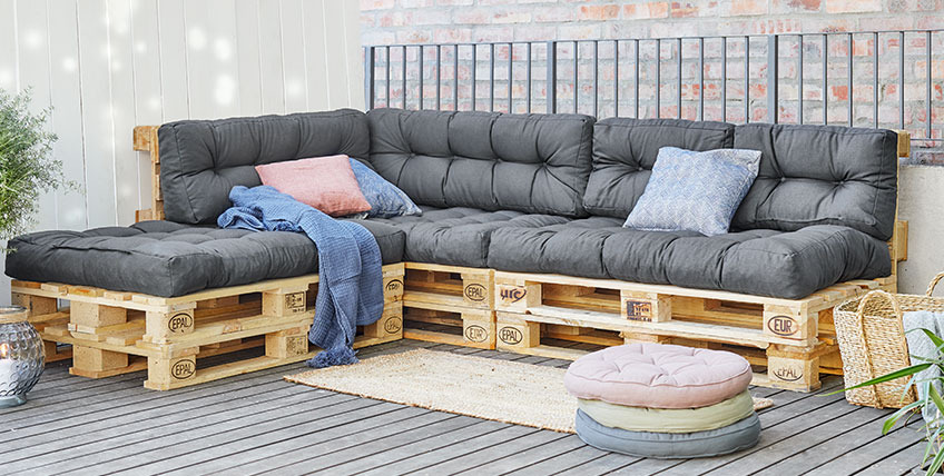 Large pallet corner sofa with open end on a patio