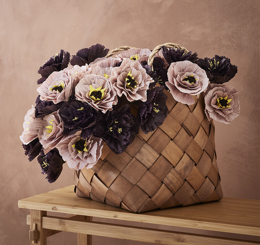 Paper flower bouquet styled in wooden basket