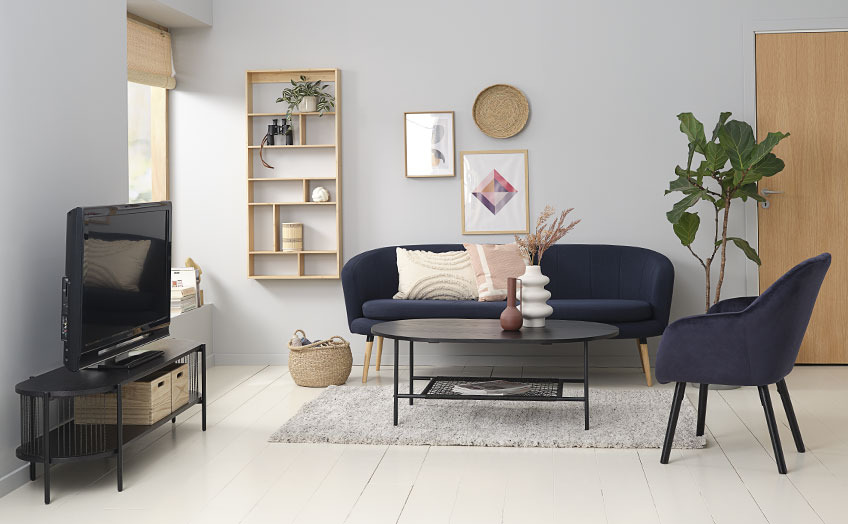 Living room with black TV bench, sofa, coffee table and armchair  